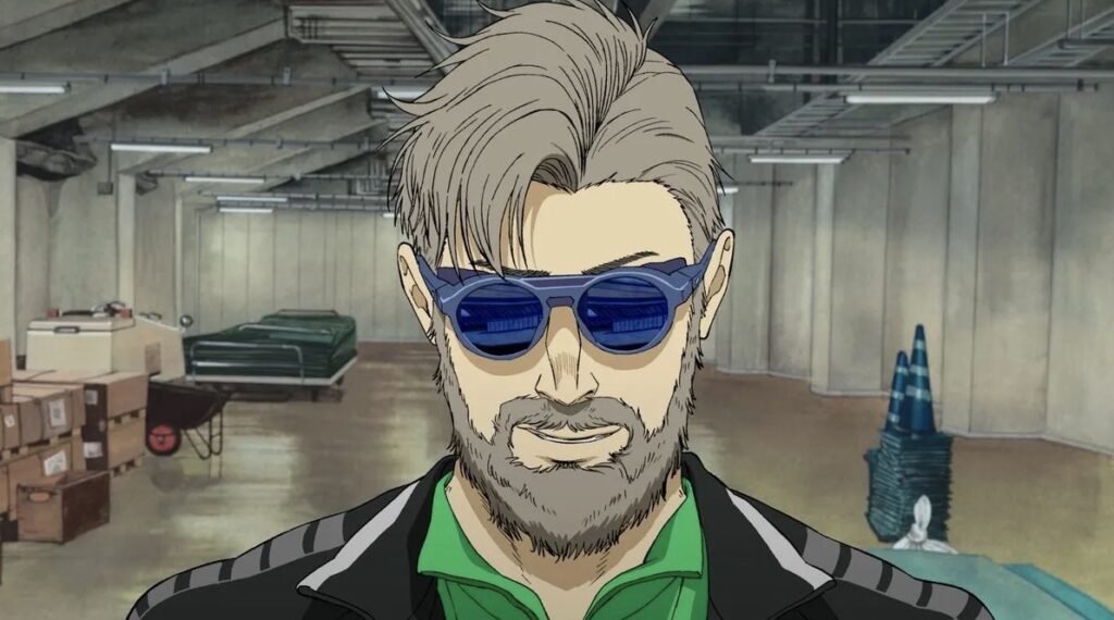 一位留著鬍子、戴著深色墨鏡的動畫角色站在地下空間中，背景可見箱子與停放設備。
